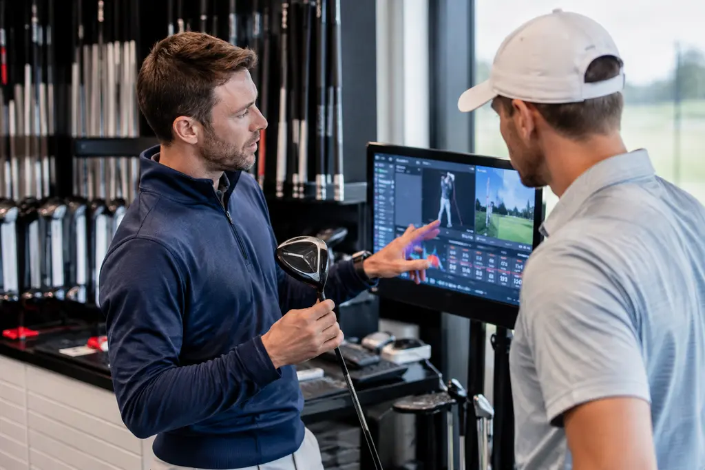 Srixon ZXi RKT woods arranged in a fitting bay beside golf balls and a launch monitor